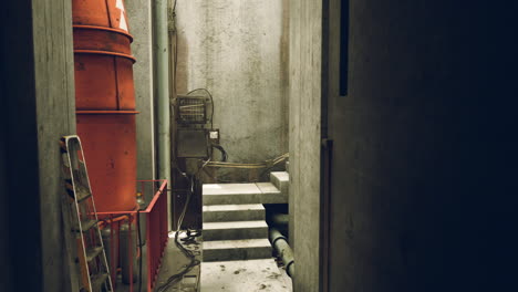 corredor industrial abandonado con escaleras y tuberías oxidadas