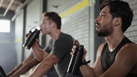 hombres bebiendo agua después del entrenamiento