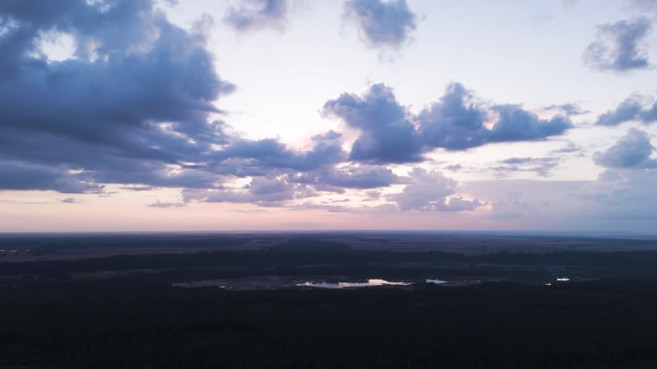 Susnet sky and stormy clouds flowing of Lihuania, aerial view