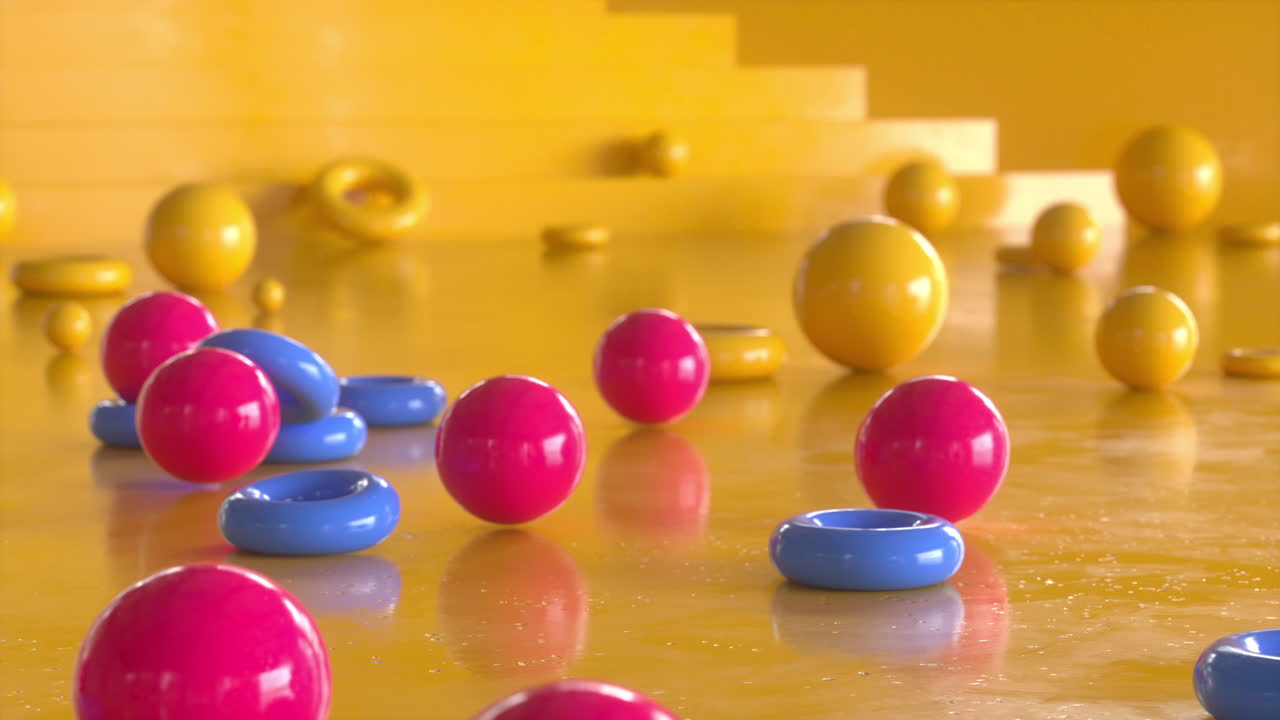 4K video animation. Colorful and shiny spheres and rings falling.
