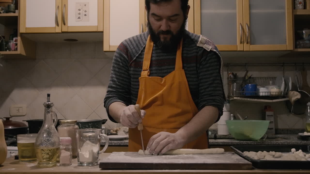 Man in Apron Preparing Homemade Gnocchi in Kitchen