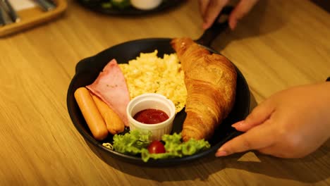 delicious breakfast platter with croissant and sausages