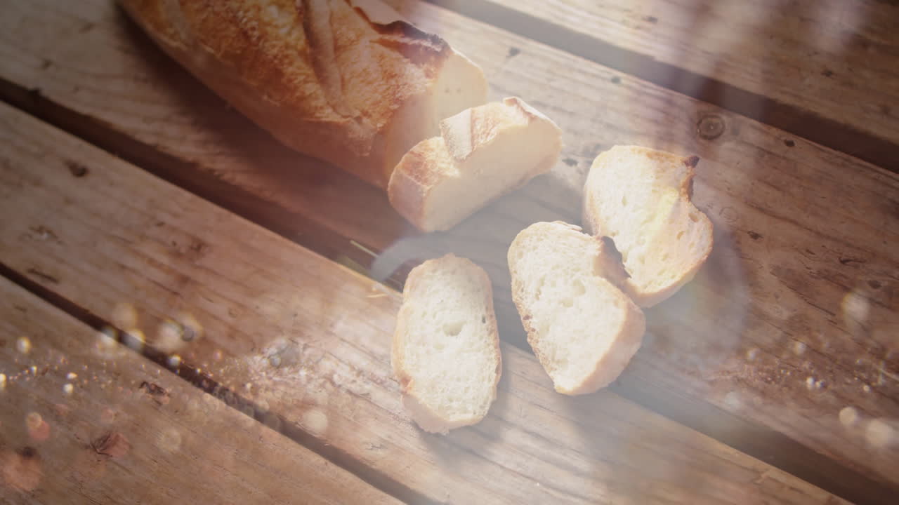 Warm sunlight streaming over sliced bread on wooden table