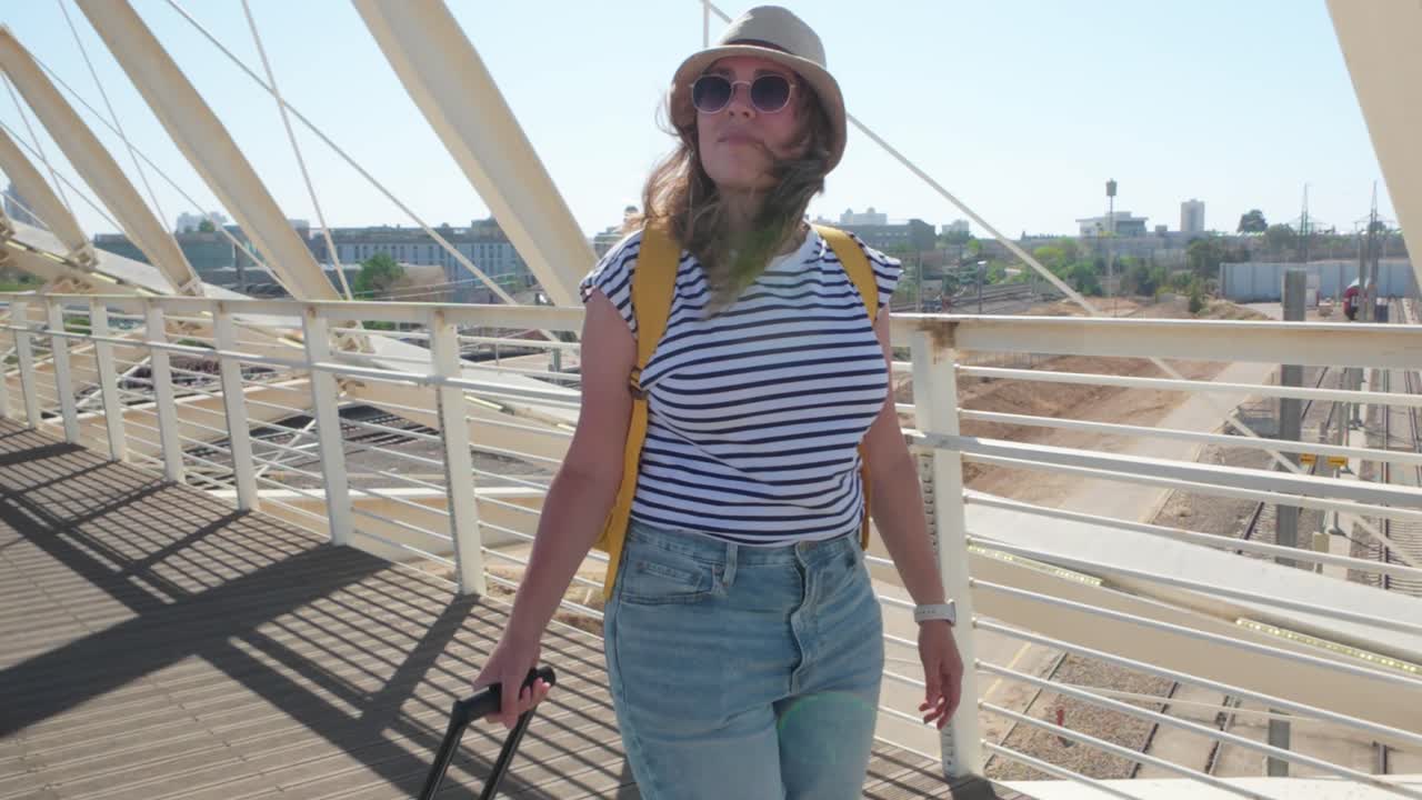 Woman with Backpack Crossing Passenger Bridge at Terminal