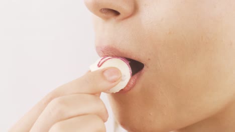 Close-up-portrait-of-woman-eating-chocolate-balls.-Eating-chocolate.