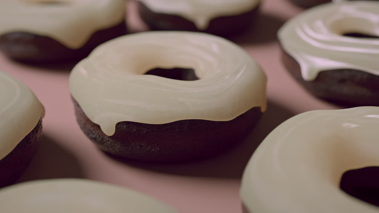 White glaze donuts on a light pink background