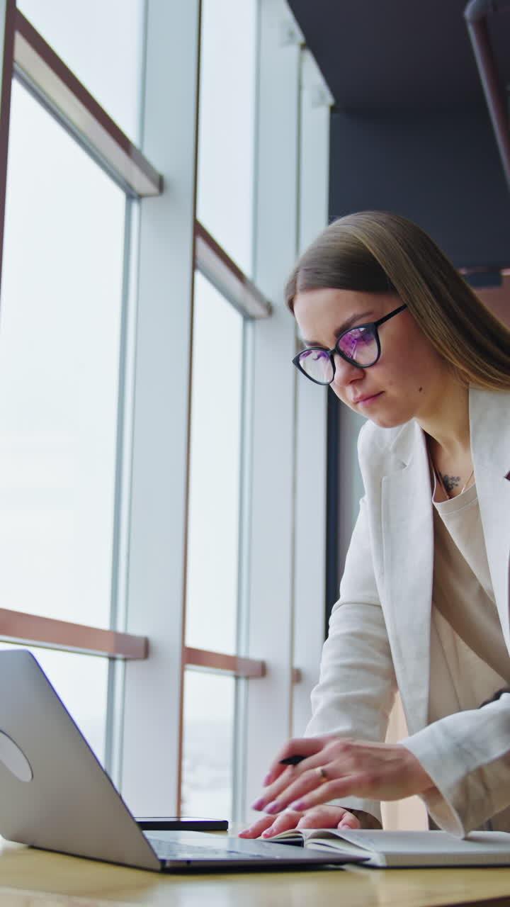 Busy pretty lady in modern office. Professional business office communication. Vertical video