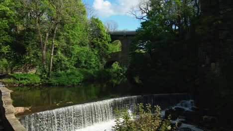 Dramatic-waterfall-aerial-shot-Torrs-Riverside-Park-Peak-District-New-Mills-UK