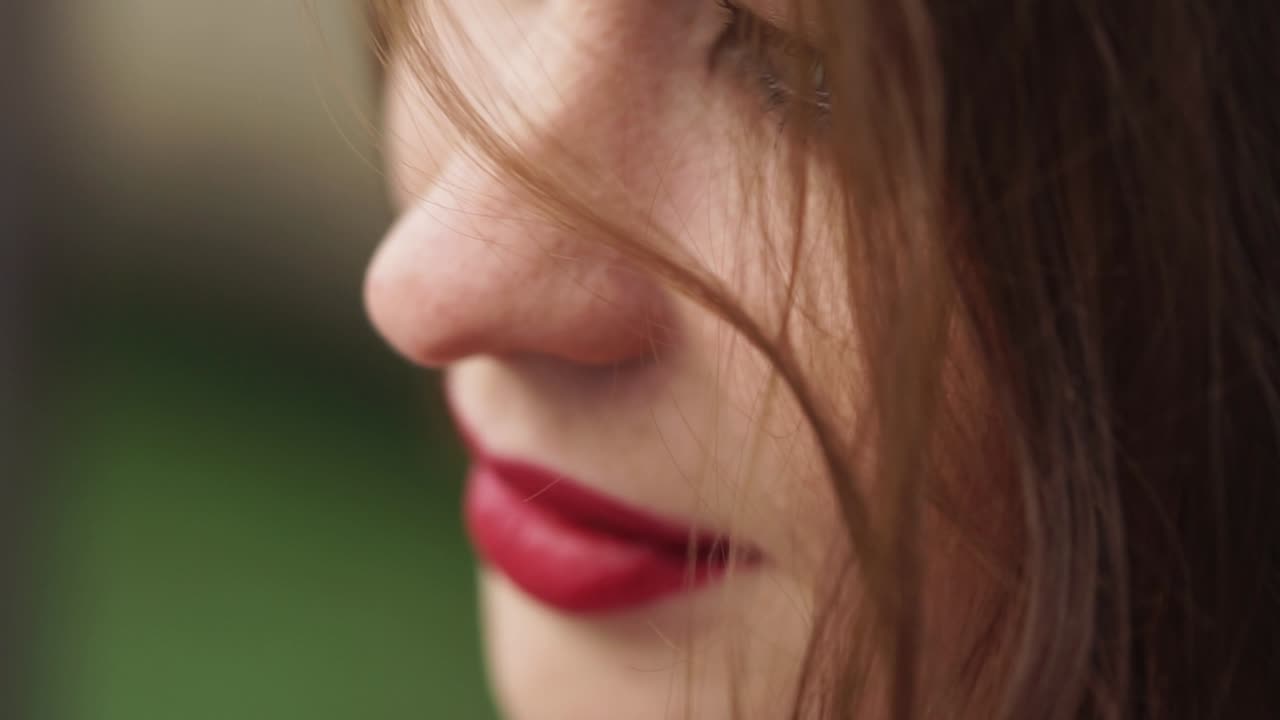 Close-up profile of a woman with red lipstick