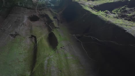 shot from an upward angle inside a rocky cave valley