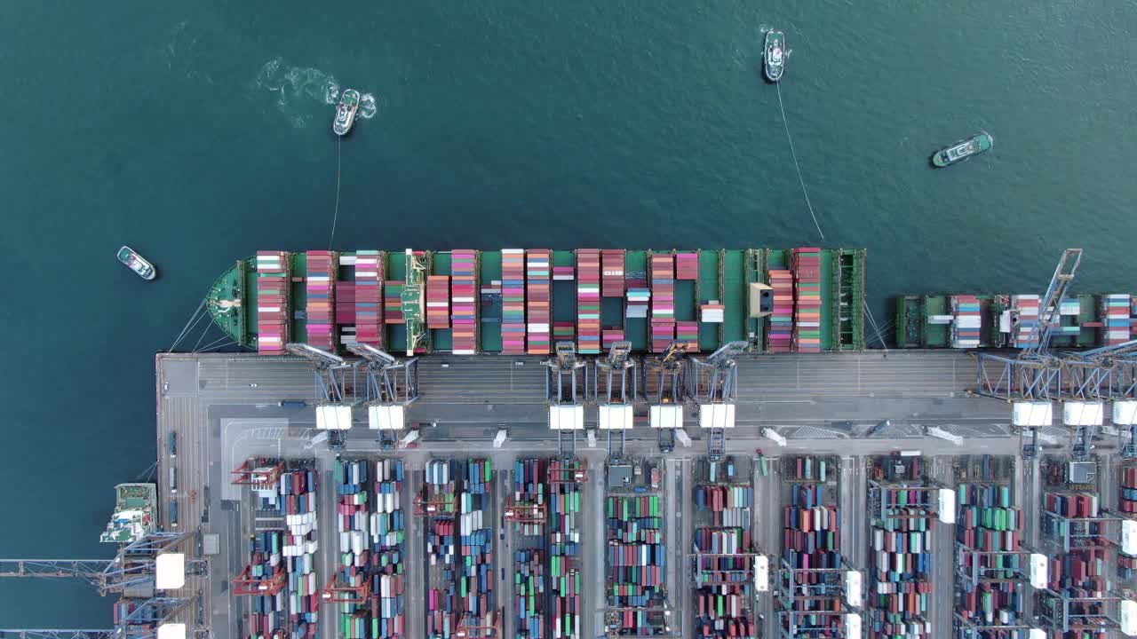 Mega Container Ship docked at Hong Kong port, during loading and unloading operation, Aerial view