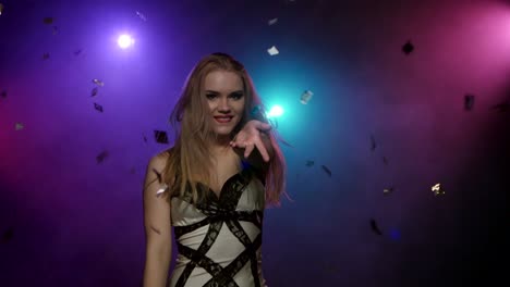 woman dancing in a nightclub with confetti