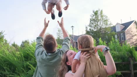 A Heartwarming Video of a Family in a Park Showing Love and Bond. A heartwarming video of a family bonding in a park, hugging, posing for pictures, holding their children. The love and bond between them is evident in this touching footage