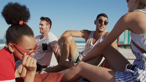 young adult friends hanging out together at the beach 4k