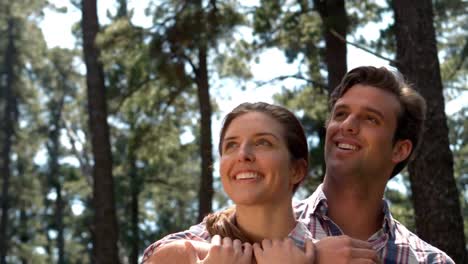 pareja sonriente en una caminata abrazándose