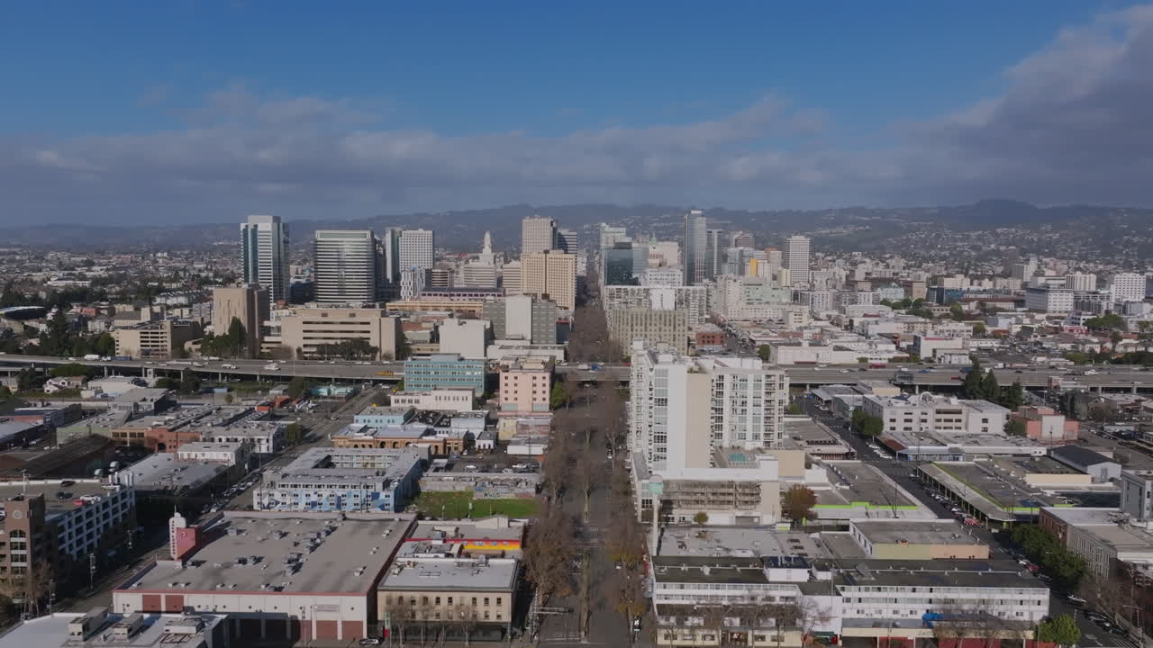 Aerial footage of downtown Oakland, California in the afternoon with traffic on the highway.