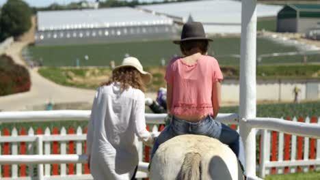 Girl-riding-a-horse-in-the-ranch-4k