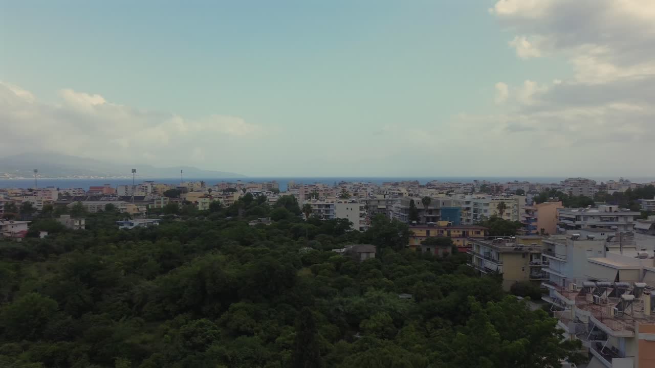 Aerial wide panoramic view of Kalamata southern part, raise up left pan drone movement, Messinian bay and Taygetos mountain on background 4K