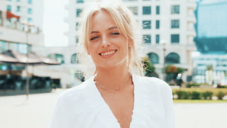 smiling woman in white robe outdoors