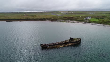 aerial footage of the wreck of juniata, an old abandoned ship at inganess bay on the mainland of orkney