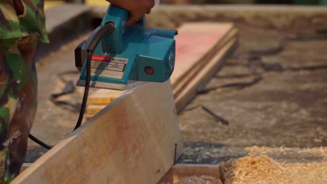 wood shavings coming out from working planer machine