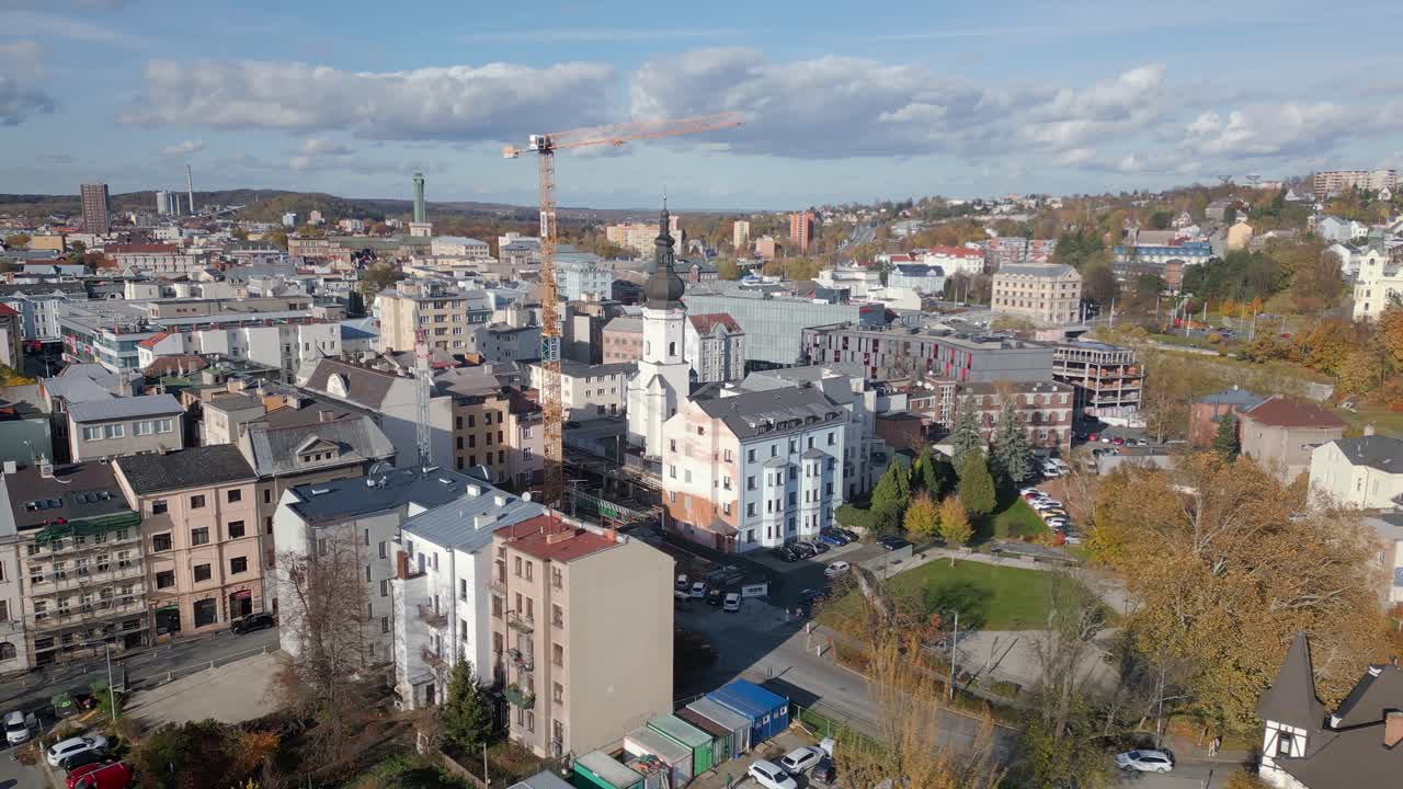 Tall tower crane above historic urban streets Ostrava Aerial cityscape