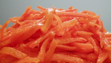 fermented marinated carrot salad, korean style chopped carrots, garlic, vegetable oil and seasonings on a turntable