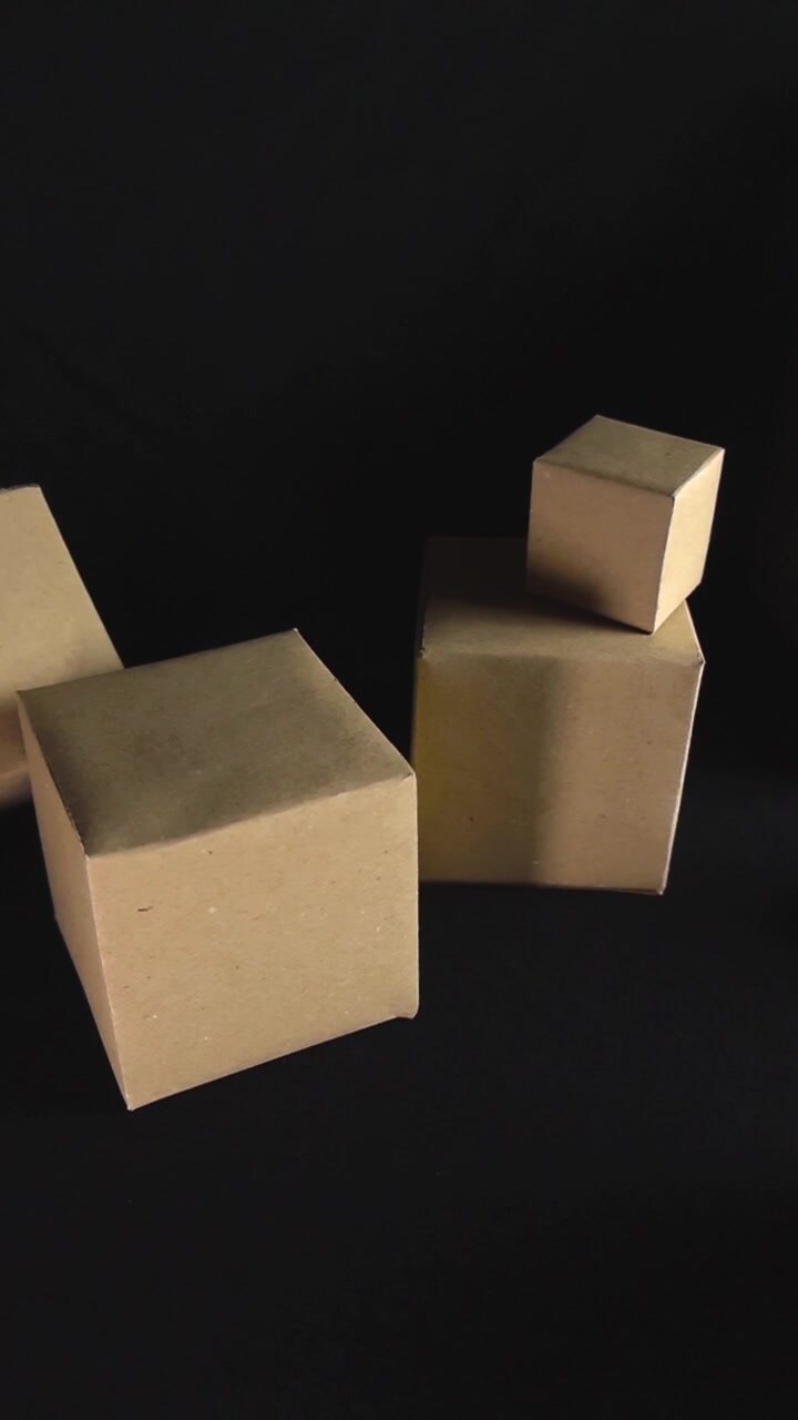 Smooth camera movement gliding past various sized cardboard boxes scattered on a dark surface, representing concepts like shipping, logistics, packaging, and e commerce with copy space