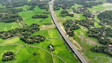 experience sri lanka's dynamic landscape with stunning aerial views of paddy fields juxtaposed against modern expressways