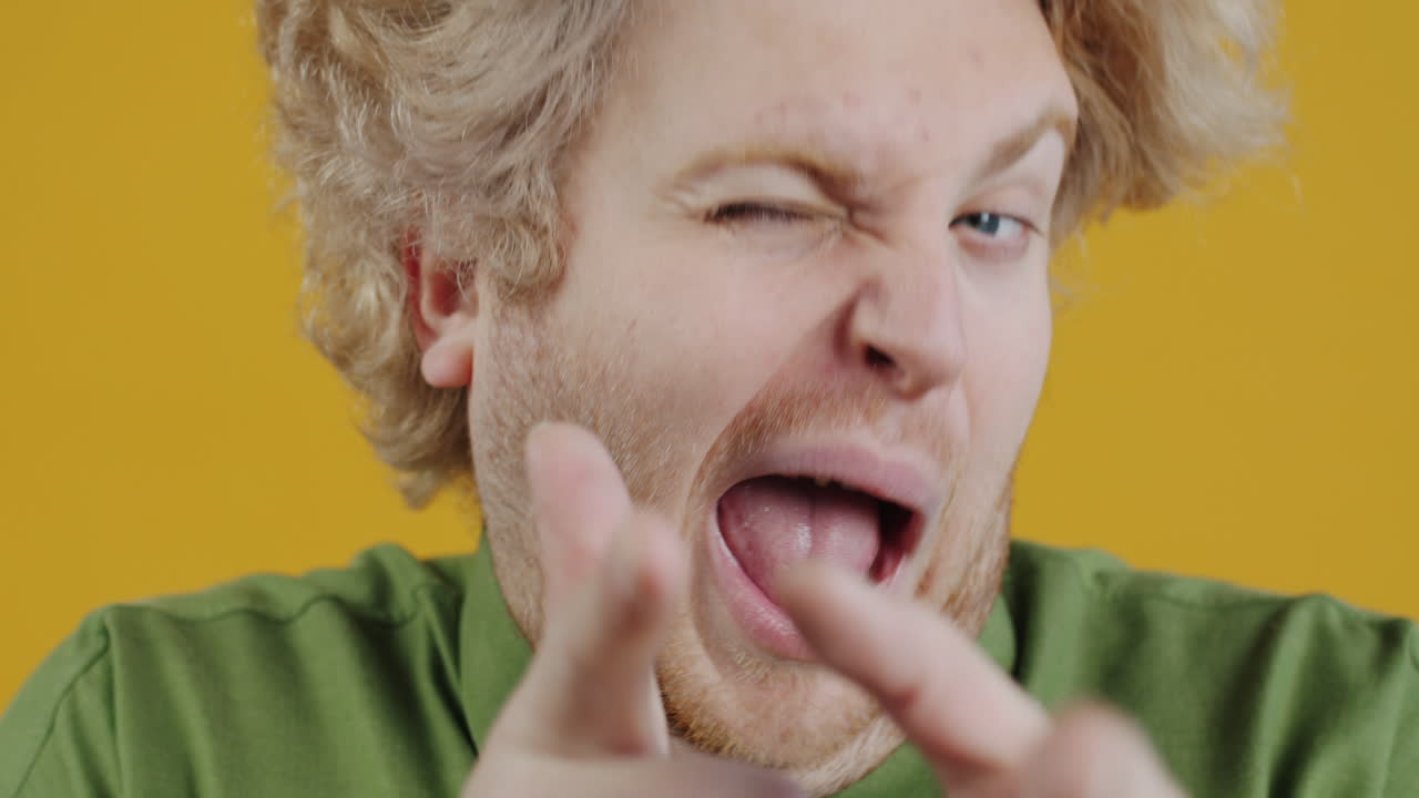 Close-up portrait of a man with blonde hair and a red beard