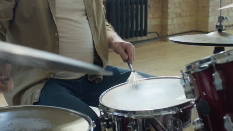 senior musician drumming in studio