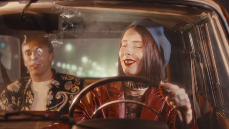 beautiful woman smoking, driving vintage car and talking to passenger