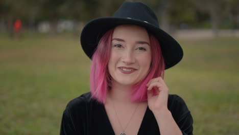 young woman with pink hair outdoors