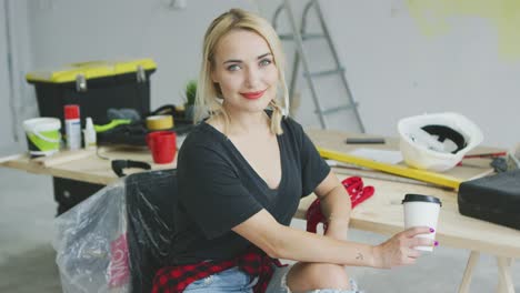 gorgeous stylish woman sitting at workbench