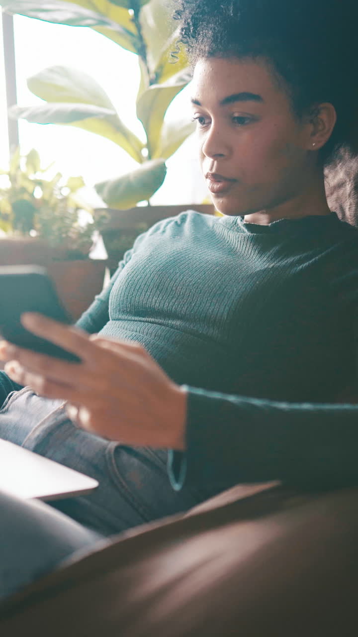 Young Woman Using Smartphone and Laptop at Home