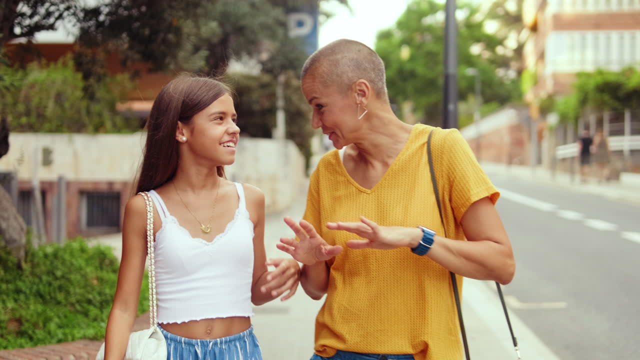 Mother and Daughter Chat on City Wall