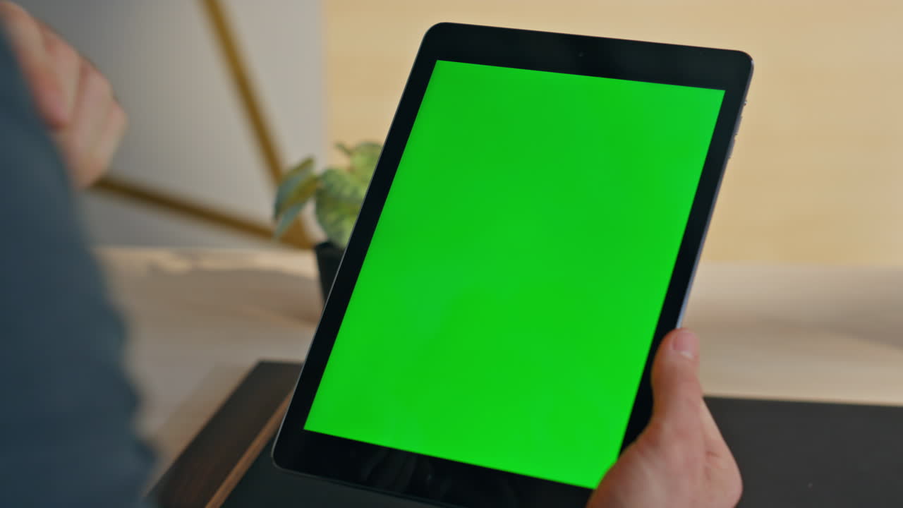 Employee finger swiping greenscreen tablet at office. Closeup manager using tab