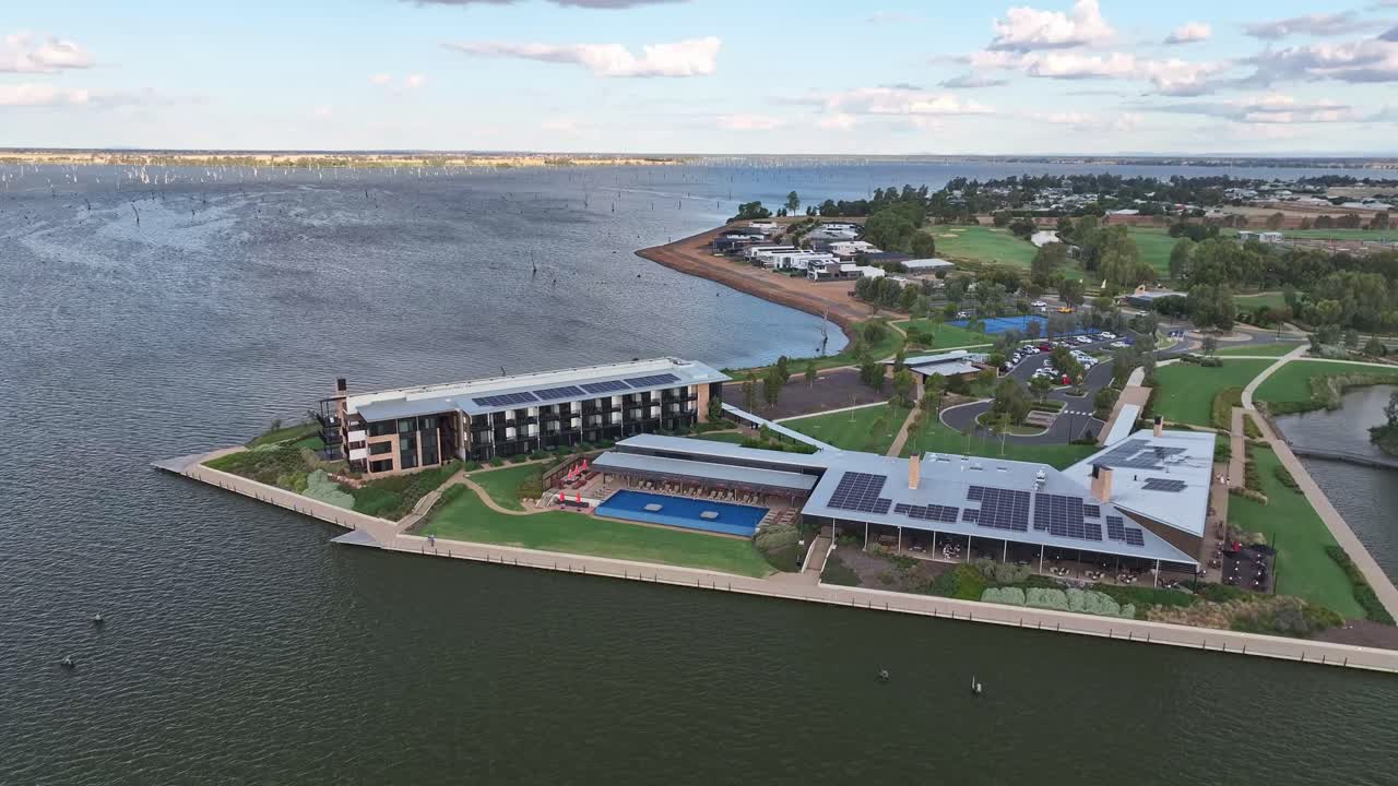 Aerial wide circular view of the Yarrawonga Sebel Hotel with Lake Mulwala and dead trees beyond