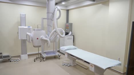 white x-ray machine in x-ray room, no people