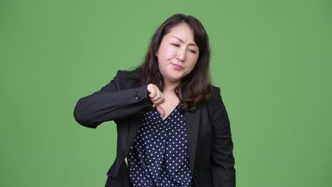 mature beautiful asian businesswoman giving thumbs down