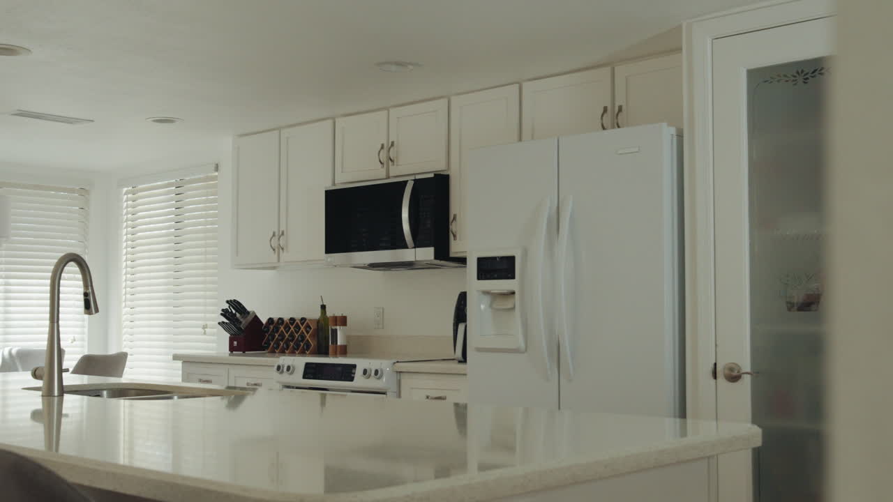 Modern kitchen interior, clean white design with appliances and natural light flowing in