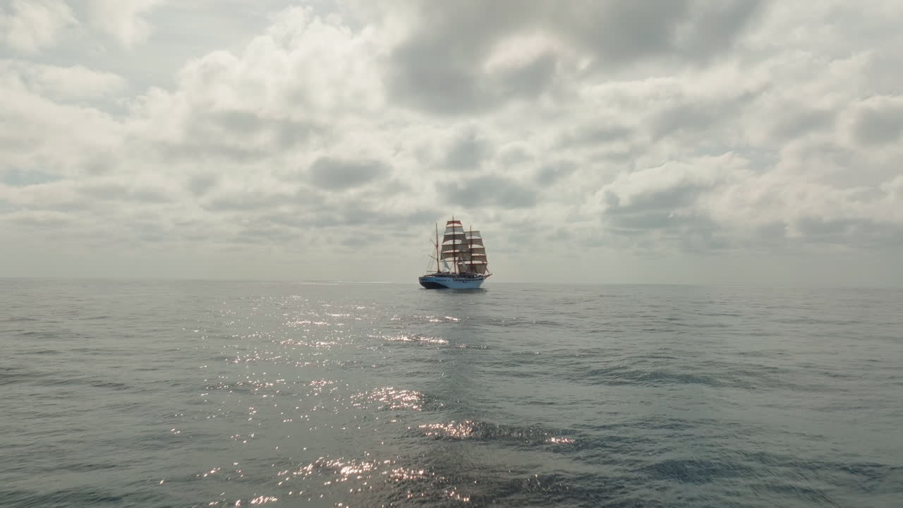 Forward drone shot of retro ship sailing on Atlantischer Ocean under cloudy day.