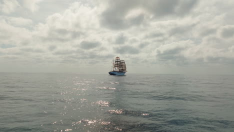 Forward drone shot of retro ship sailing on Atlantischer Ocean under cloudy day.