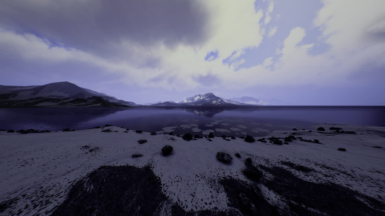 Serene lakeside view with mountains and clouds during twilight hours