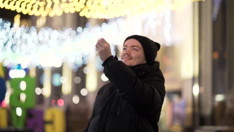 man with sparkler in city at night