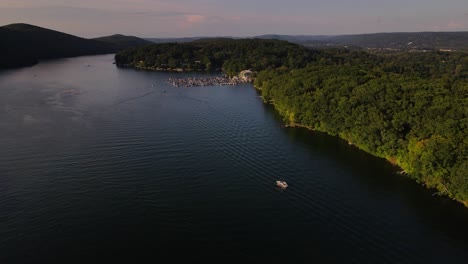 broad view of lake with boat, marina and seaplane on a warm spring day over rippling water