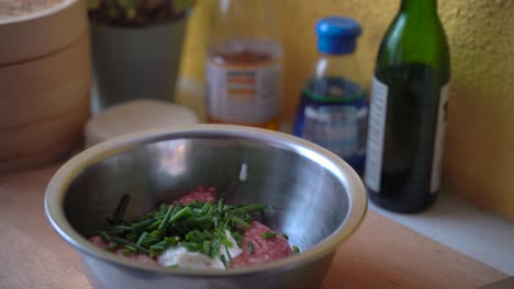 Seasoning-bowl-of-raw-ingredients-for-Japanese-Gyoza-Dumplings-with-salt-and-pepper