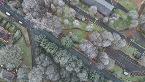 Top-view-of-a-uk-road-in-winter-with-frost-covered-trees-and-cold-look