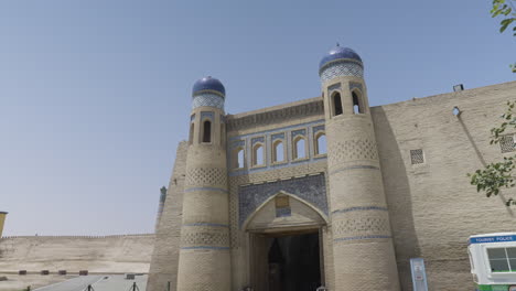 revealing shot of the east gate of palvan darvoza during daytime in khiva, uzbekistan