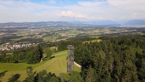 aerial drone shot flying around the pfannenstiel observation tower in the canton of zürich, switzerland with the countyside in the background